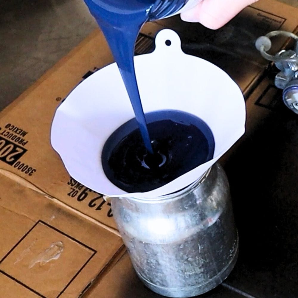 photo of adding paint into sprayer using a paint filter