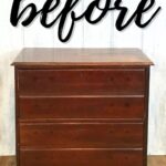 A worn, dark wood dresser with four drawers and the word before written above it.