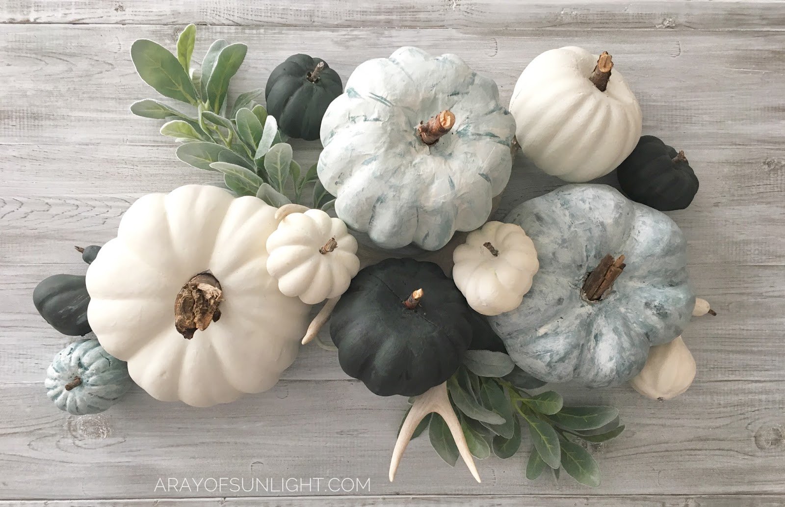 chalk painted pumpkins with green stems and deer antlers