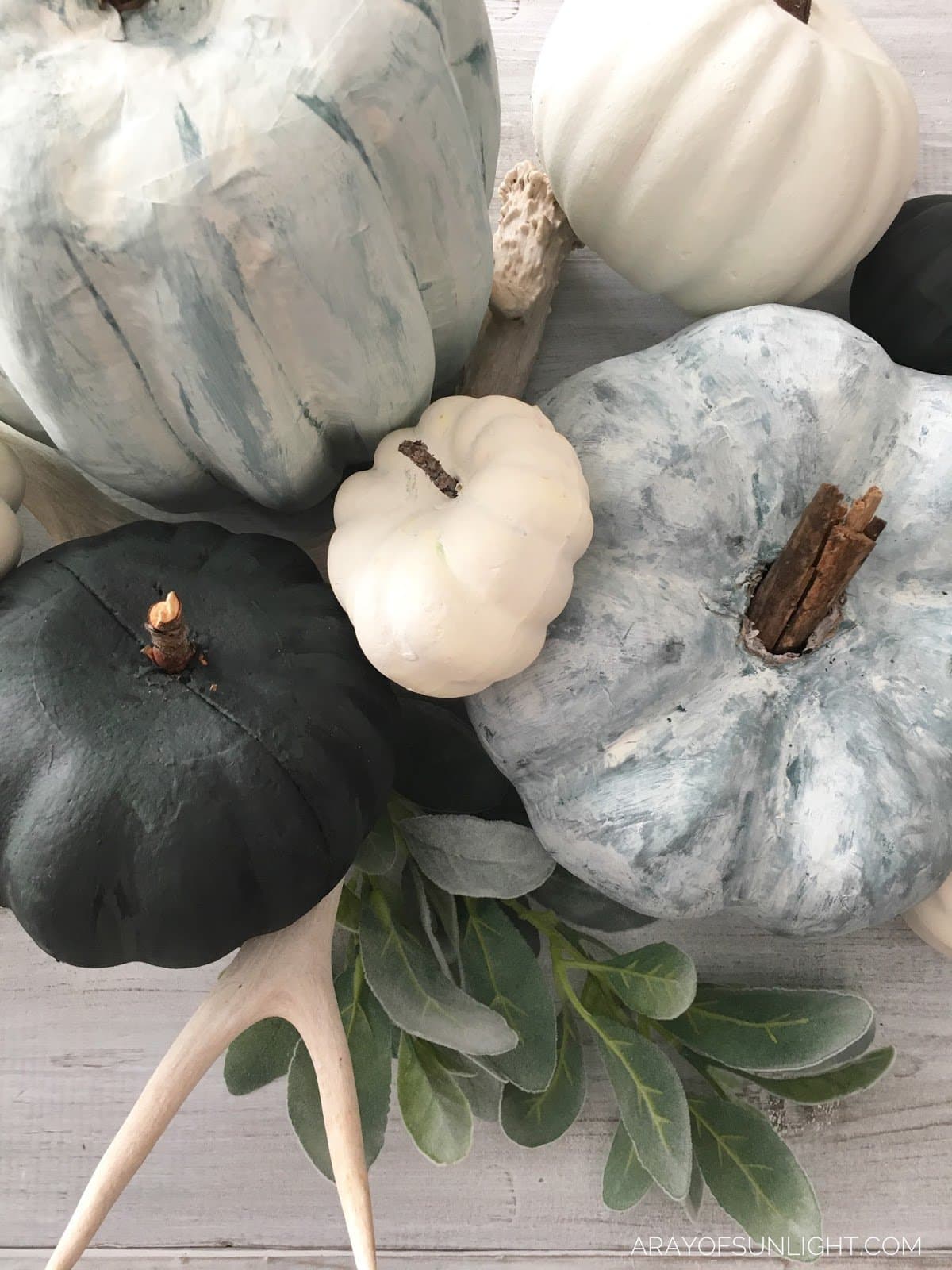blue, green and white chalk painted pumpkins
