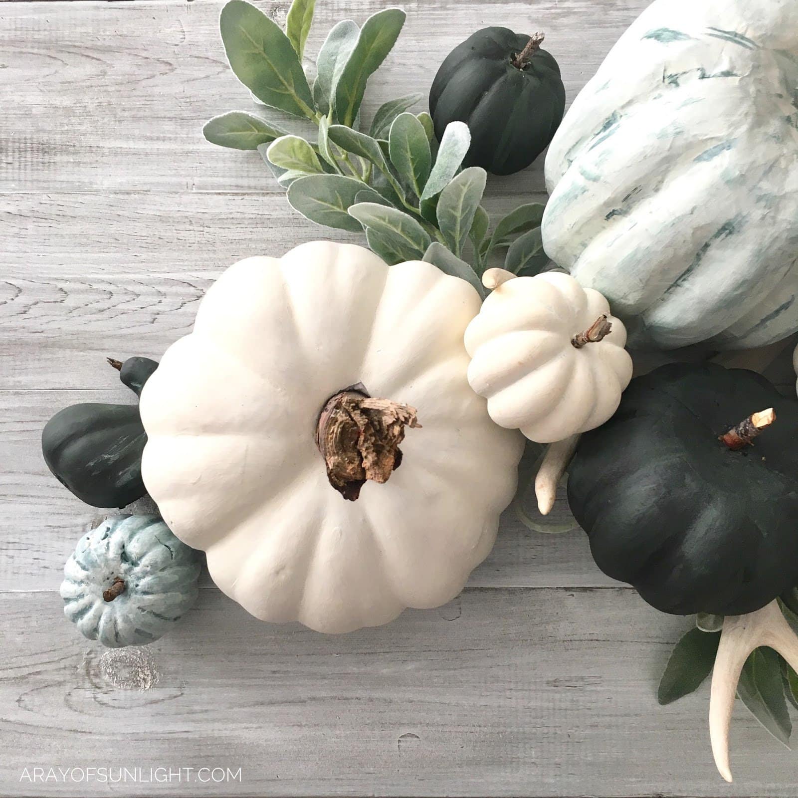 foam painted pumpkins with wooden branch stems