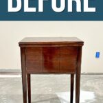 A small, dark wood sewing table before makeover