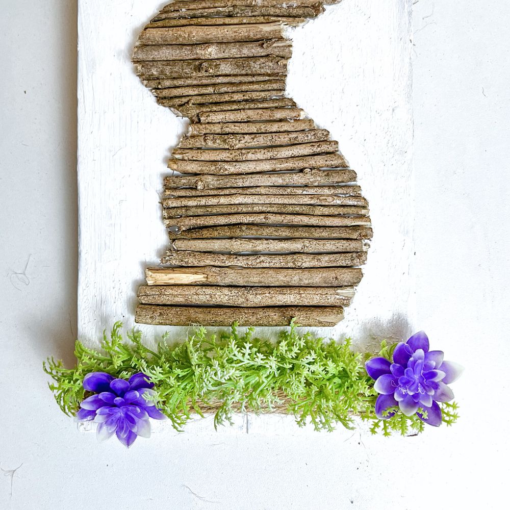 photo of adding artificial flowers and leaves to Easter bunny sign