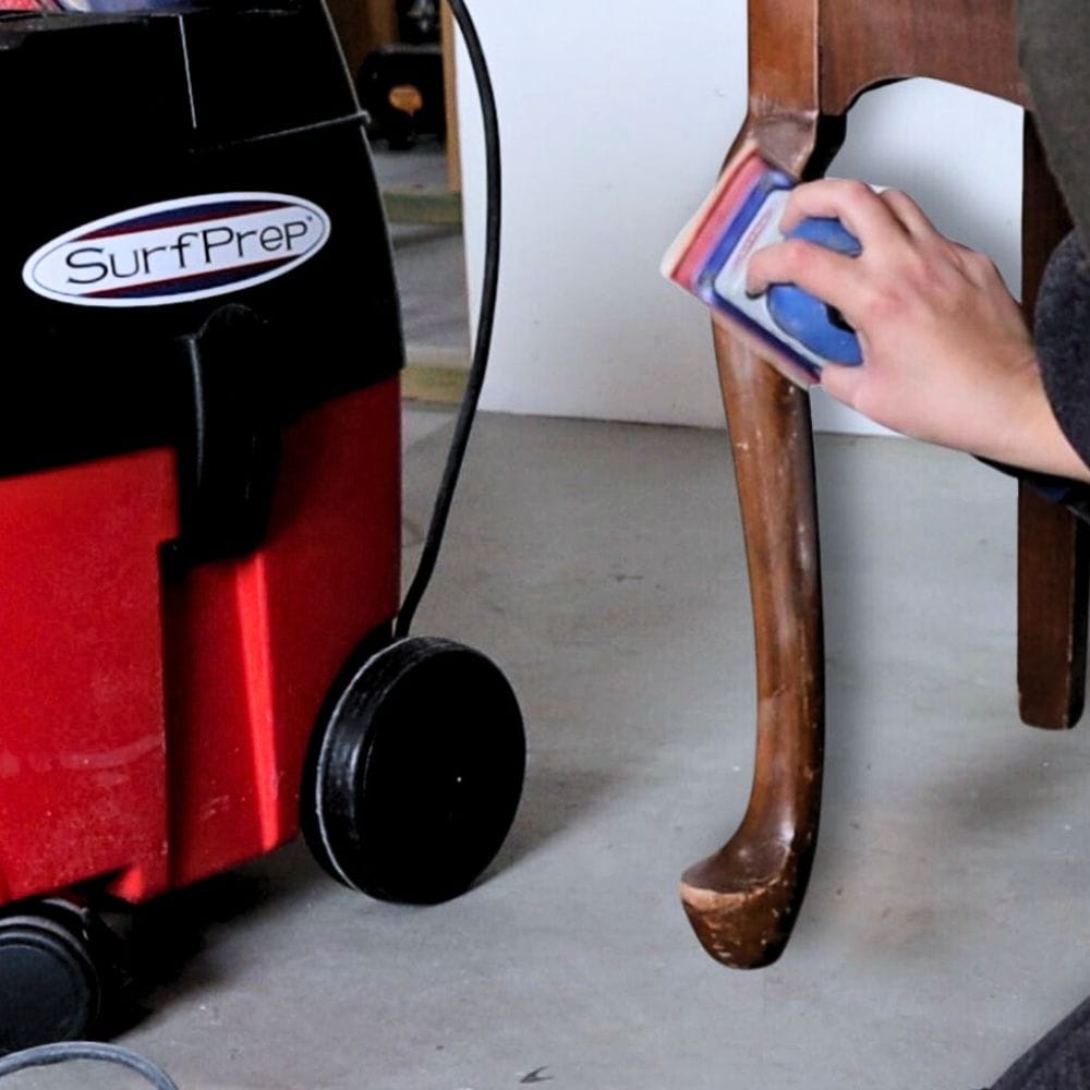 photo of sanding end table using surfprep sander attached to a surfprep vacuum
