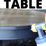 A hand uses a paint sprayer on a dining room table; text reads Best Paint for Dining Room Table.
