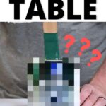Person holding a paintbrush over a pixelated object with text: Best Paint for Dining Room Table.