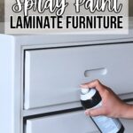 Hand holding spray can, painting white laminate dresser; text reads “Can You Spray Paint Laminate Furniture.”.