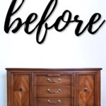 A wooden sideboard against a white wall