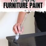 A hand painting a black table with a brush, text reads: Best No Sand Furniture Paint.