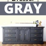 Gray painted dresser with gold handles on a wooden floor