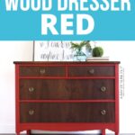 A wood dresser painted red on the bottom with dark wood drawers, against a white wall.