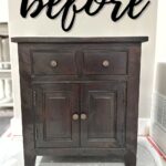 Dark wooden cabinet with "before" sign in black cursive wall art.