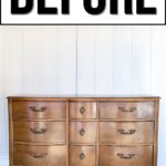 A worn wooden dresser with brass handles labeled BEFORE above it, against a white wall.