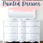 White chalk-painted dresser with ornate details and a matching mirror, set against a light background.