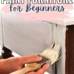 Hand painting white paint on wooden furniture with text: How to Paint Furniture for Beginners.