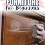 A gloved hand sanding a wooden dresser with the text Sanding Furniture For Beginners above.