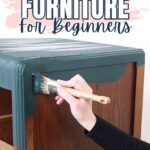 A hand painting a wooden dresser with dark green paint; text reads Flipping Furniture For Beginners.