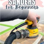 Hand holding a yellow electric sander on a wooden surface, with text Best Sanders for Beginners.
