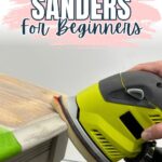 A hand uses a green electric sander on a wooden table. Text reads Best Sanders for Beginners.
