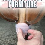 Hands applying wood filler to a chipped wooden furniture leg