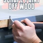 Close-up of hands using a scraper tool to remove paint from a wooden surface