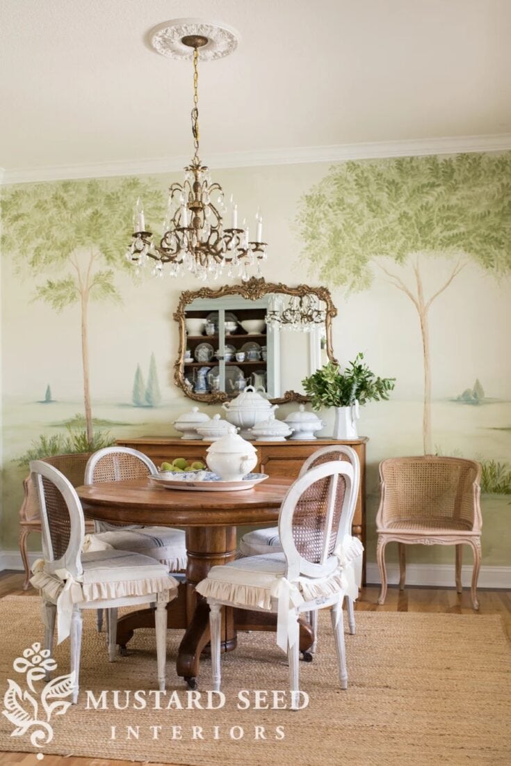 Elegant dining room with a round table, vintage chairs, and chandelier