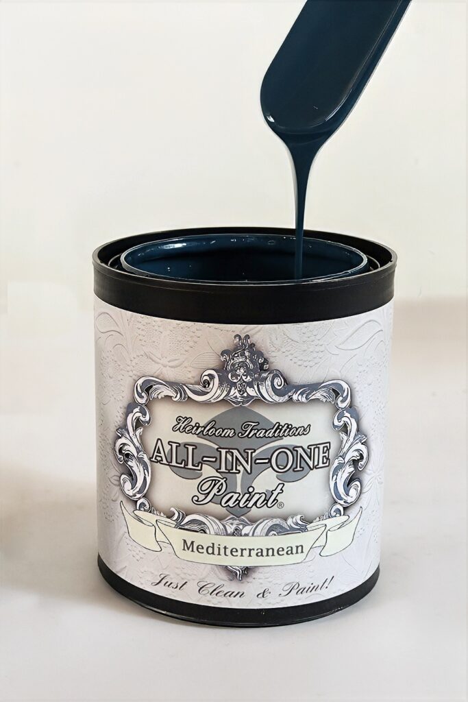 Open can of All-In-One Paint labeled Mediterranean, with dark blue paint being poured into it.