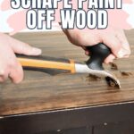 Hands using a scraper to remove paint from a wooden surface,