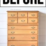 A light wood dresser with brass handles sits against a white shiplap wall. BEFORE is written above.