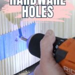 A person drills new hardware holes in wood marked with blue painter’s tape.