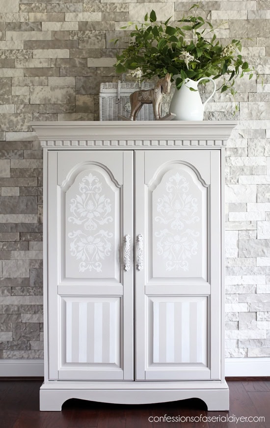 White decorative cabinet with floral and striped patterns