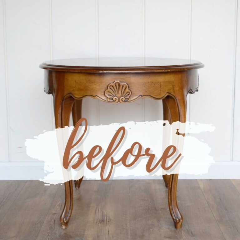 Round wooden table with curved legs and before written across it in script on a white paint stroke background.