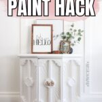 White vintage cabinet with ornate details, framed art, and plants. Text: No Sanding Furniture Paint Hack.