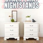 Two white chalk-painted nightstands with decor on top, on a wood floor against a white wall.