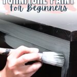 A hand painting a dark wooden dresser with white paint; text reads Best Types of Furniture Paint For Beginners.
