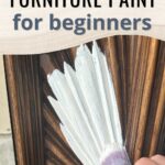 Hand painting white paint onto carved wood, with text