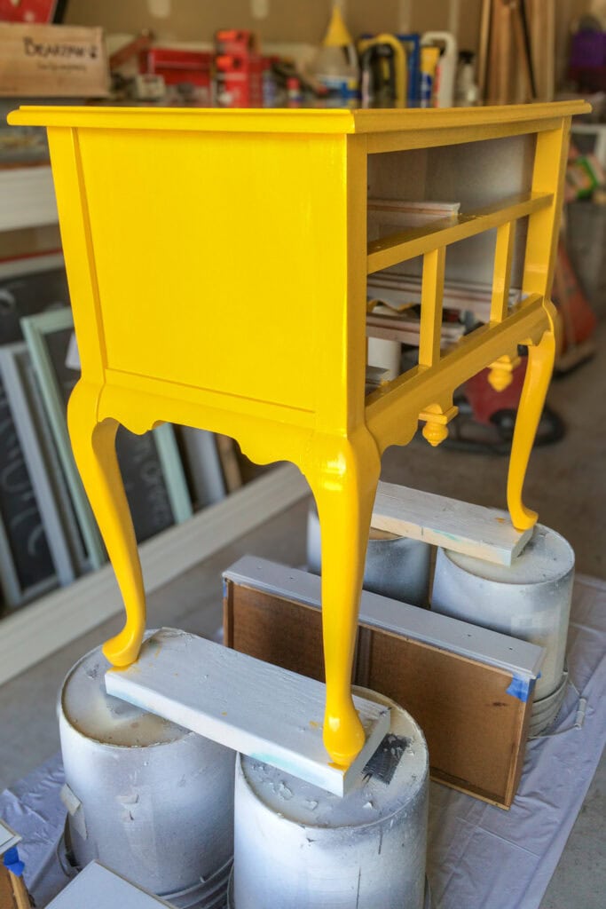 A bright yellow table is on top of buckets