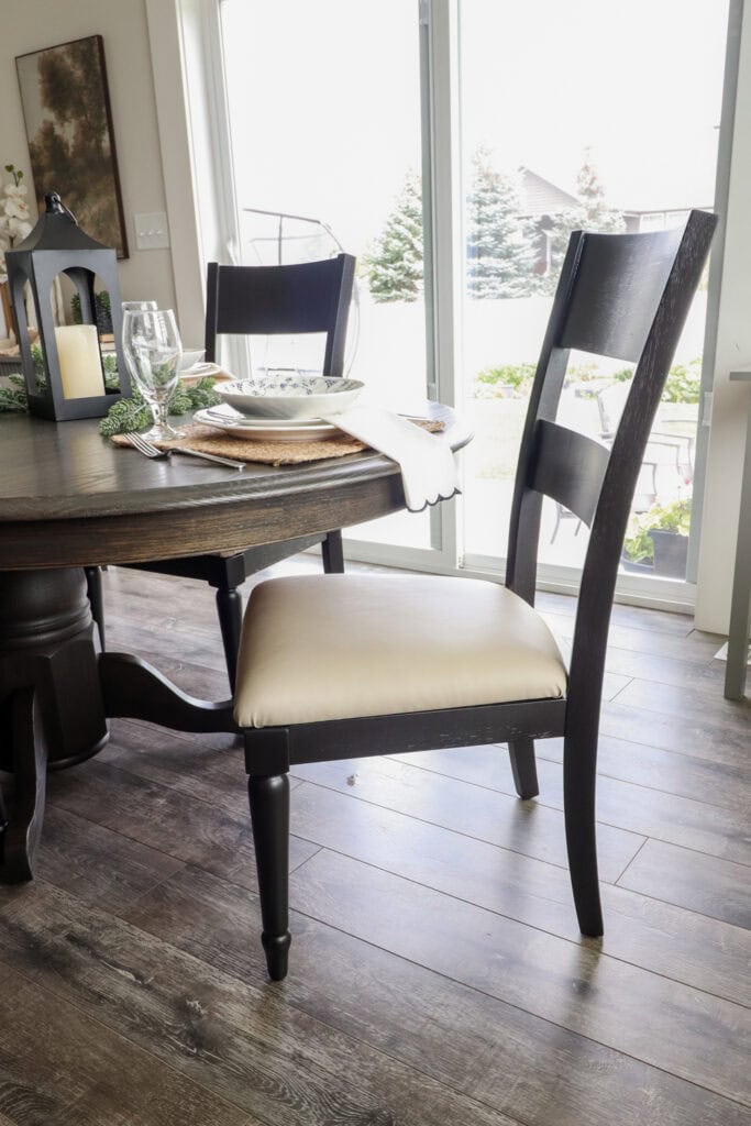 Closeup of wooden dining chair and table with dark finish