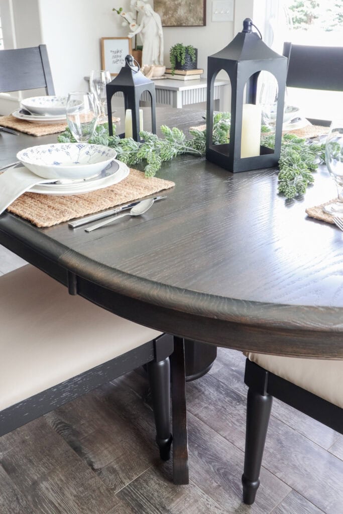 Closeup on dark wood dining table set with decor