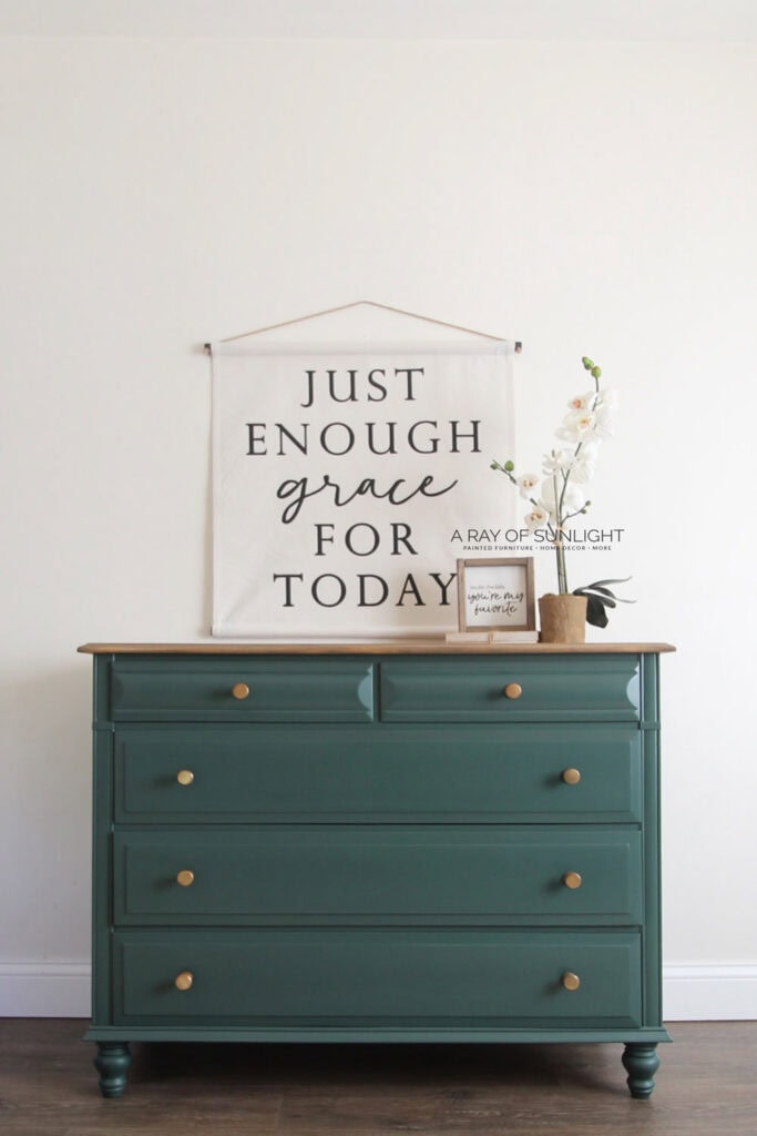 A green painted dresser with new turned legs