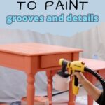A person uses a paint sprayer to paint a table in coral color