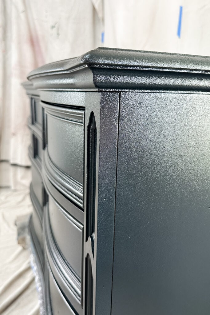 Closeup of texture on dark colored dresser