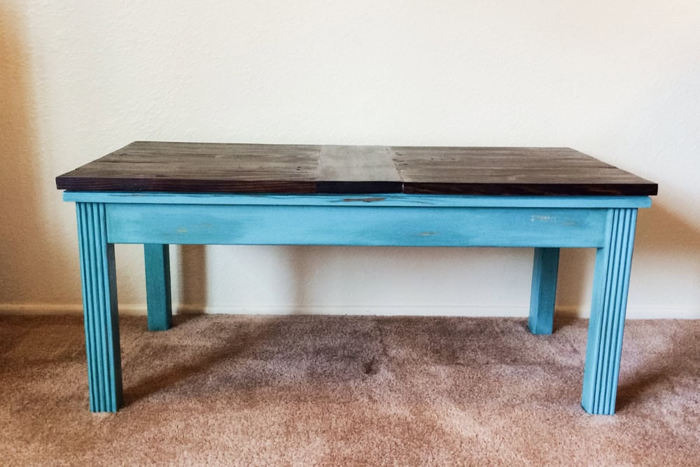 Rectangular wooden coffee table with blue base and a dark brown top