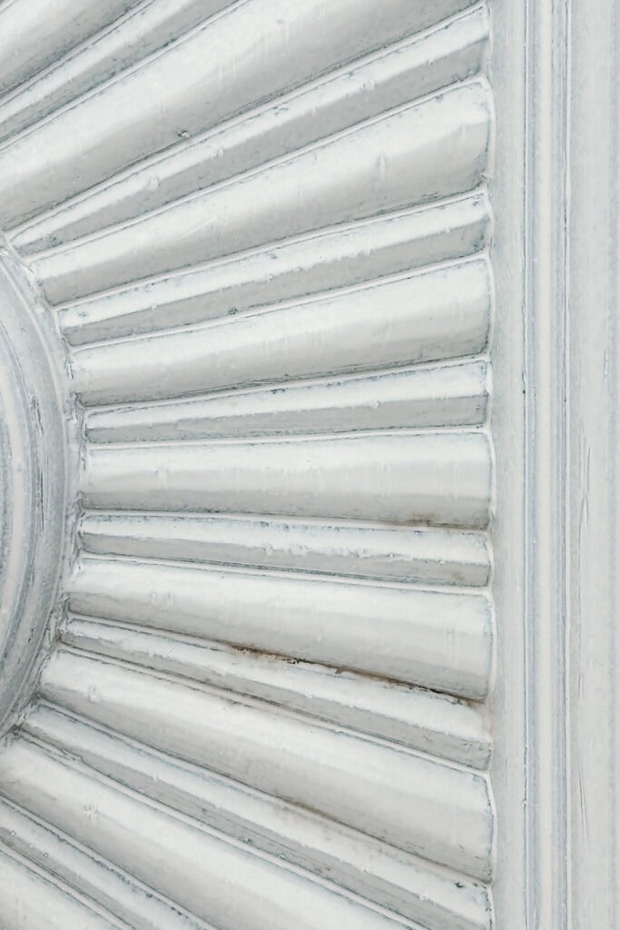 Closeup of a white painted surface with some brown spots