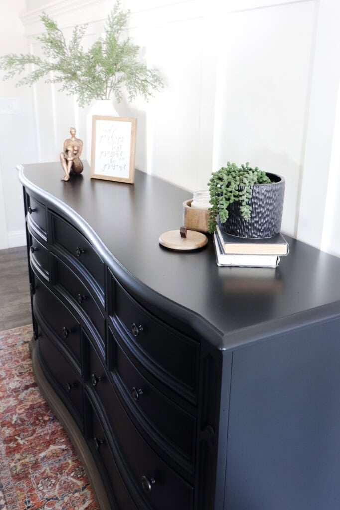 Closeup of black furniture with decor on top
