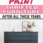 A dark green dresser with decor on top