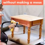 Spray painting a wooden table indoors