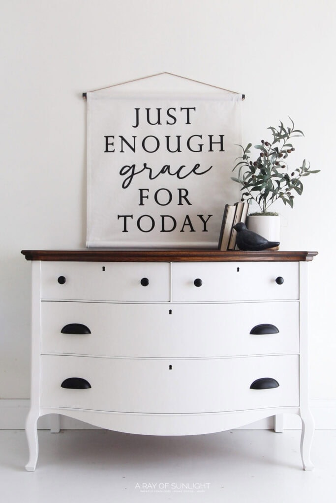 White dresser with dark handles and stained top