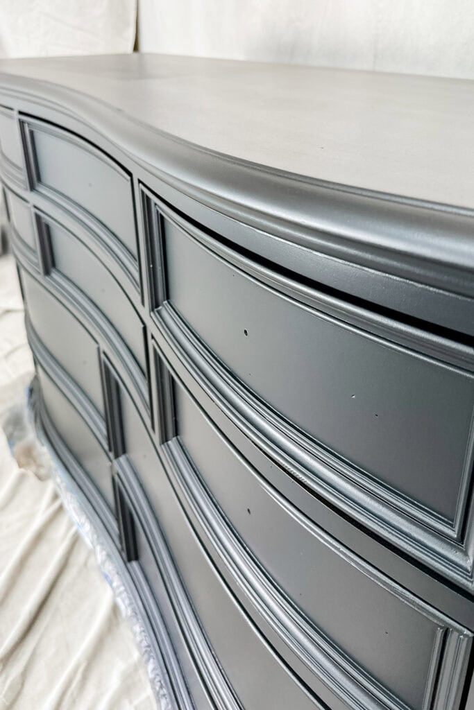 Closeup of black dresser with smooth finish