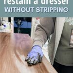 Person wipes stain on wooden top